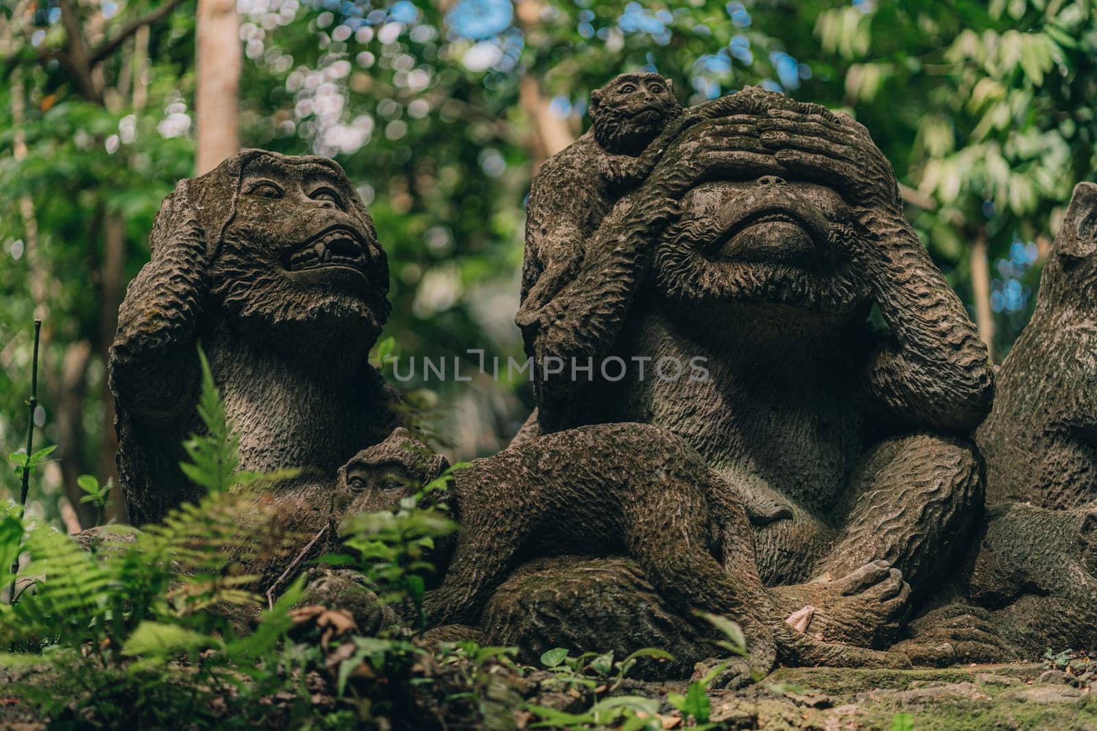 Stone monkeys statues in sacred monkey forest. Old decorative monkey sculptures in ubud sacred forest