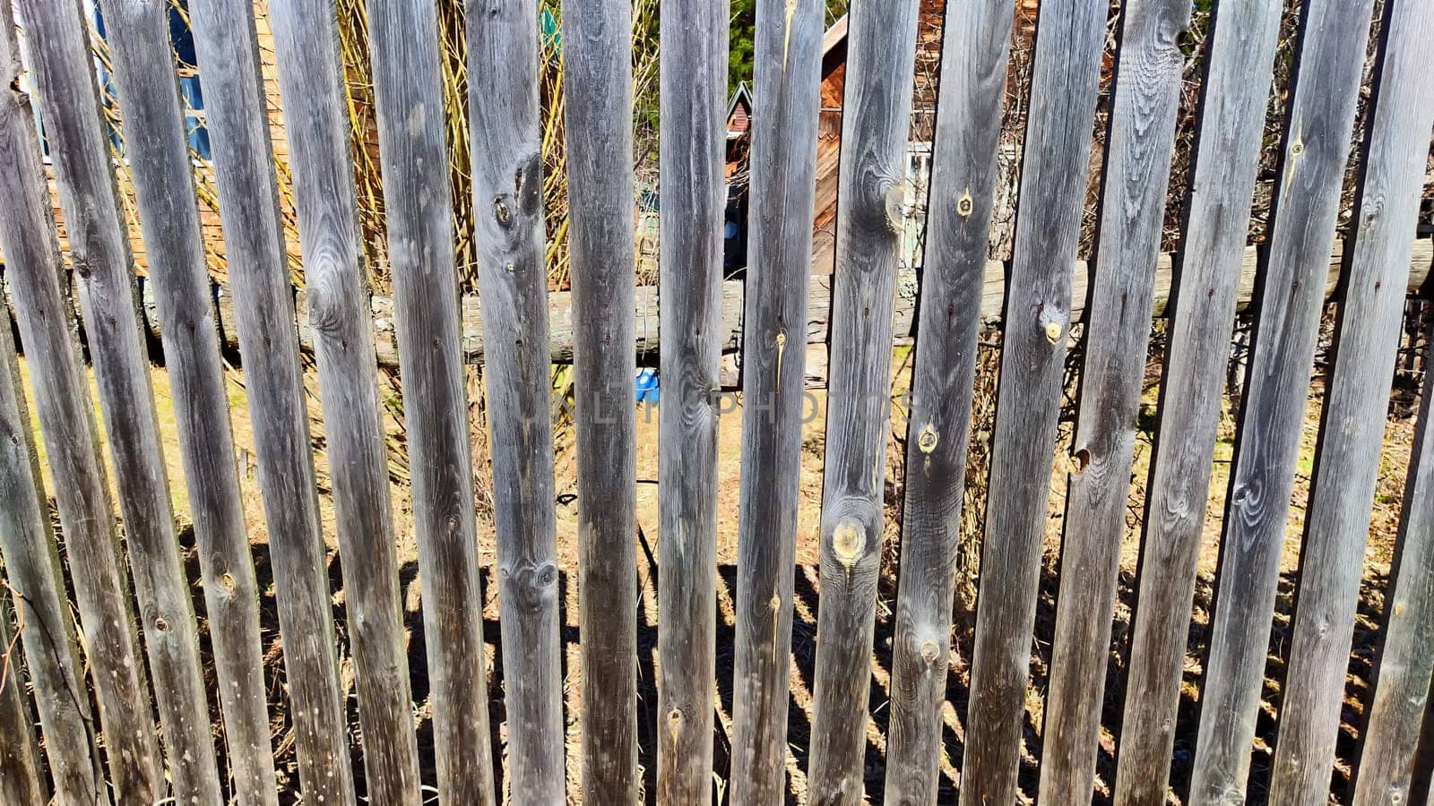 Old wooden planks in fence. Background and texture. Abstract frame and copy space. Ancient Wooden rustic rural fence