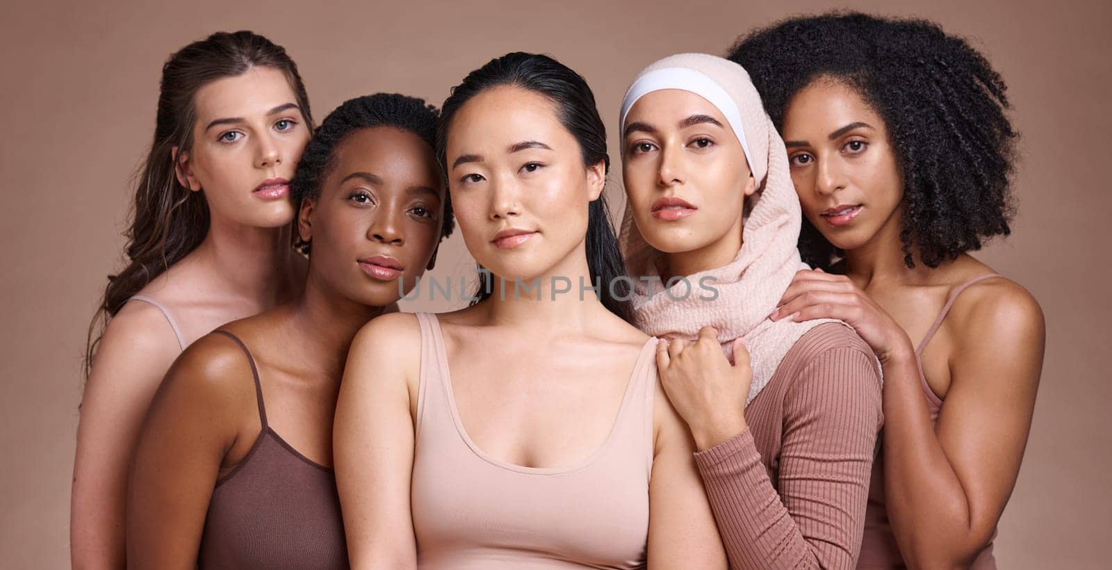 Portrait, beauty and diversity with a model woman group in studio on a brown background for inclusion. Face, natural and different with a female and friends posing to promote health or equality.