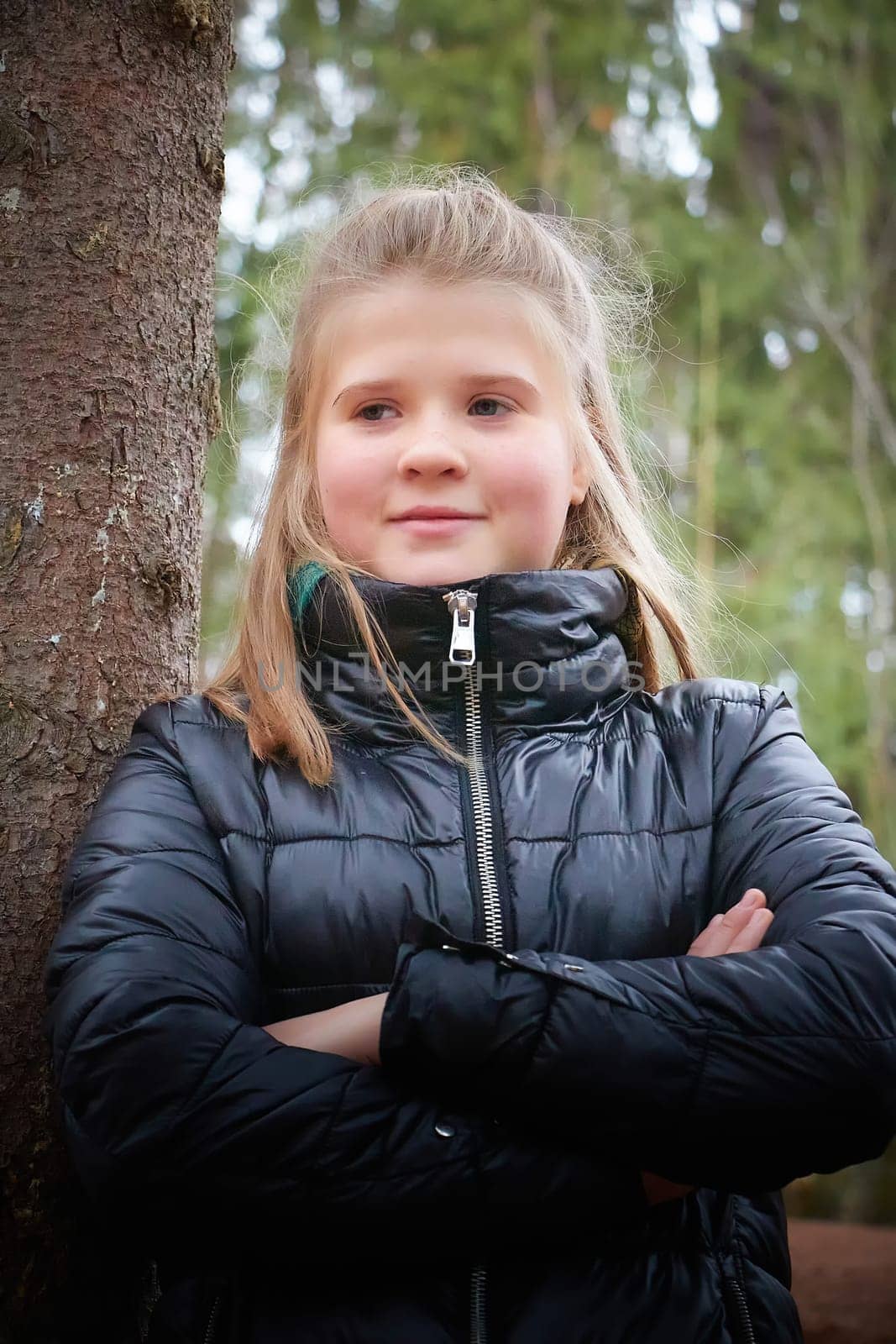 Kirov, Russia - October 23, 2022: Cute teenager blonde girl enjoying outdoors in city park in autumn day