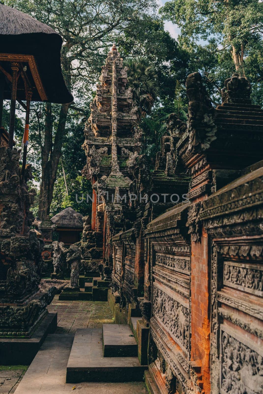 Side view photo of balinese temple architecture in sacred monkey forest by Popov