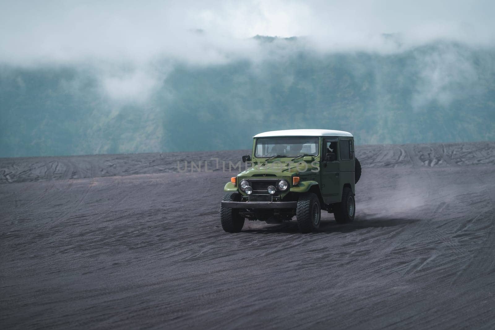 Travelling jeep driving trip in Bromo mount volcano territory. Vehicle journey in Semeru savanna field