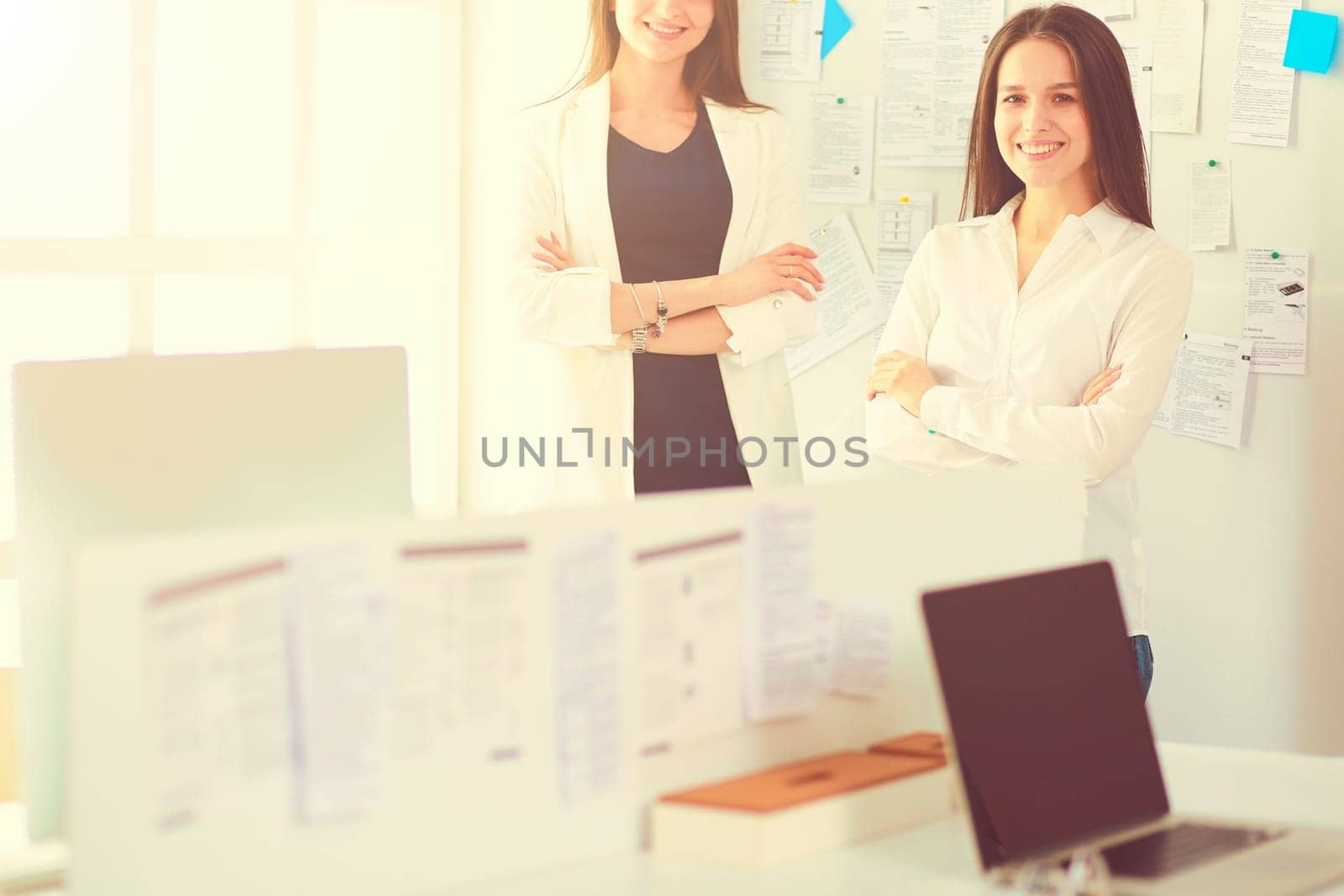 Smiling businesswoman or helpline operator with headset and computer at office.