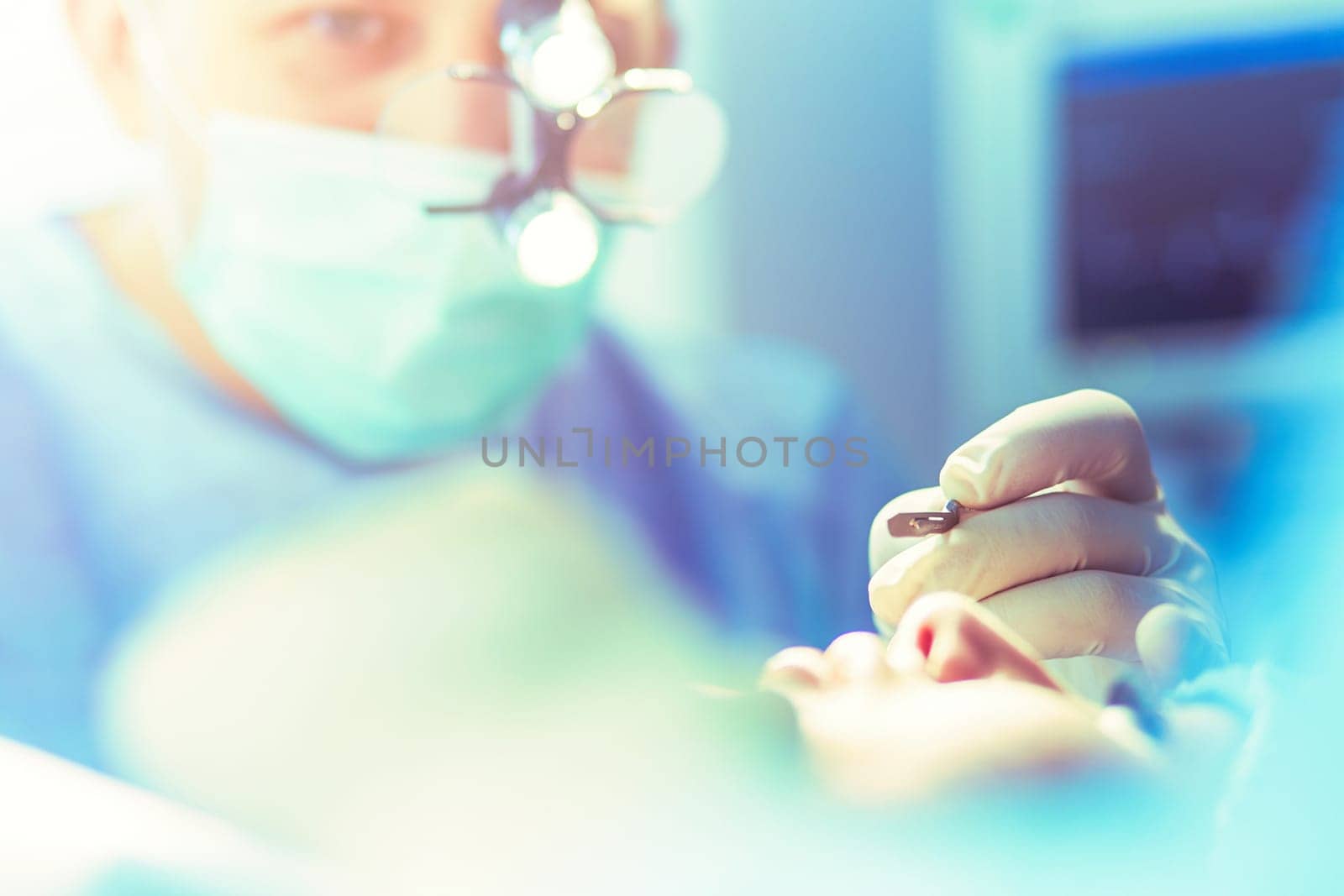 Man surgeon at work in operating room.