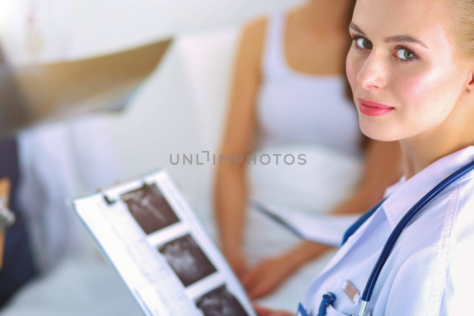 Surgeon and doctor analyzing x-ray together in medical office .