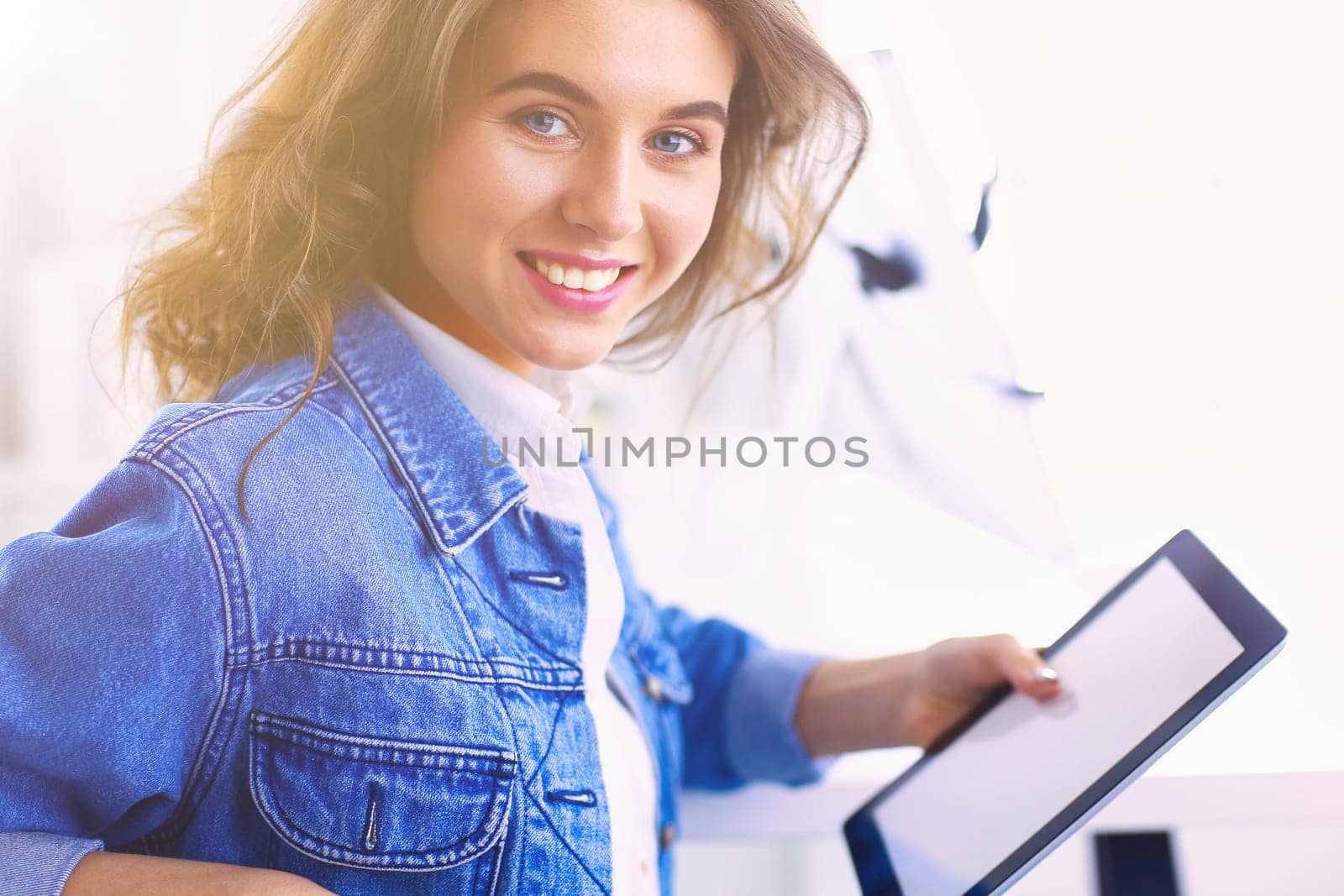 Portrait of beautiful business woman working at her desk with headset and laptop.