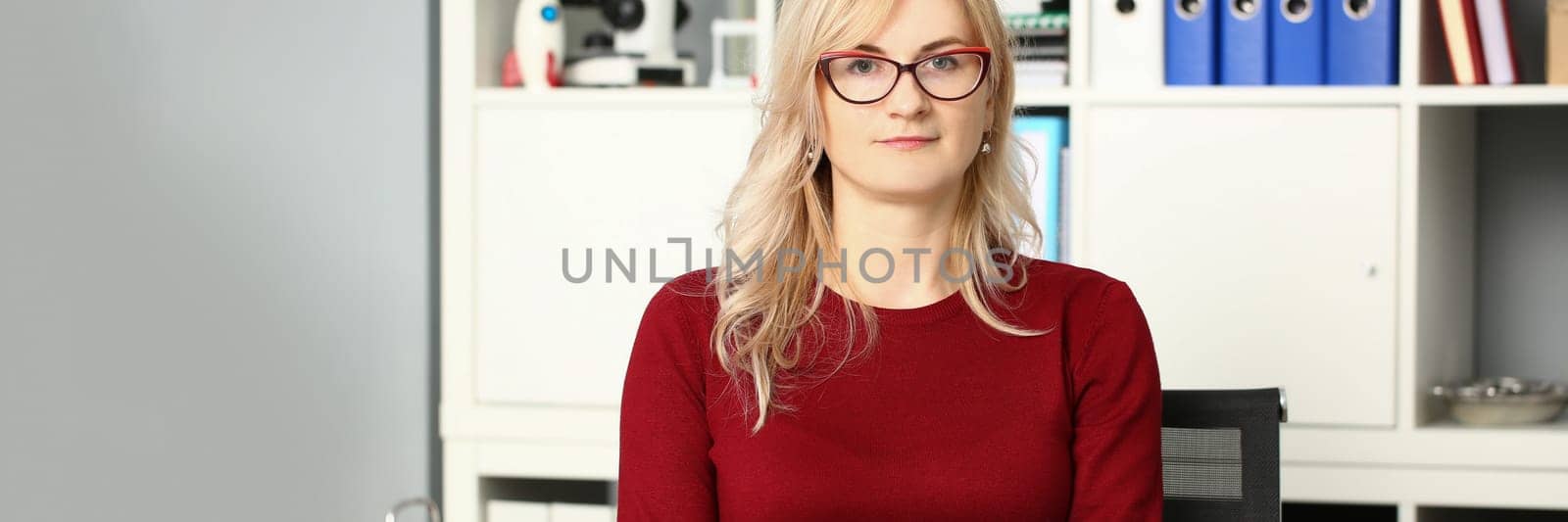 Portrait of businesswoman in glasses at workplace in office. Business consultant secretary or manager