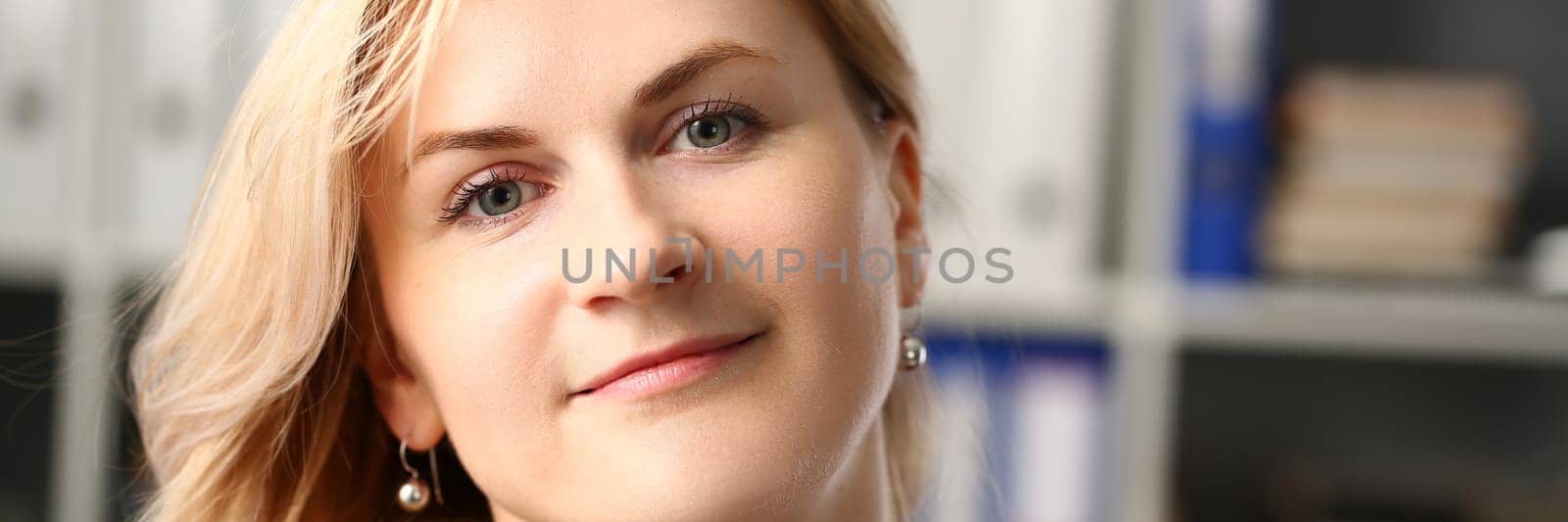 Portrait of a beautiful smiling blonde businesswoman at workplace. Business consultant manager or leader concept
