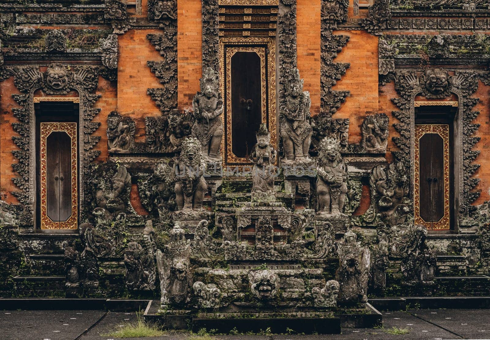 Ubud temple decorative stone statues. Balinese religious sacred architecture, stone curved sculptures