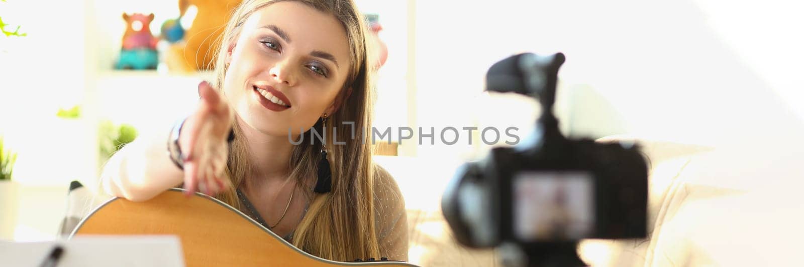 Female musician recording guitar teaching videos closeup by kuprevich