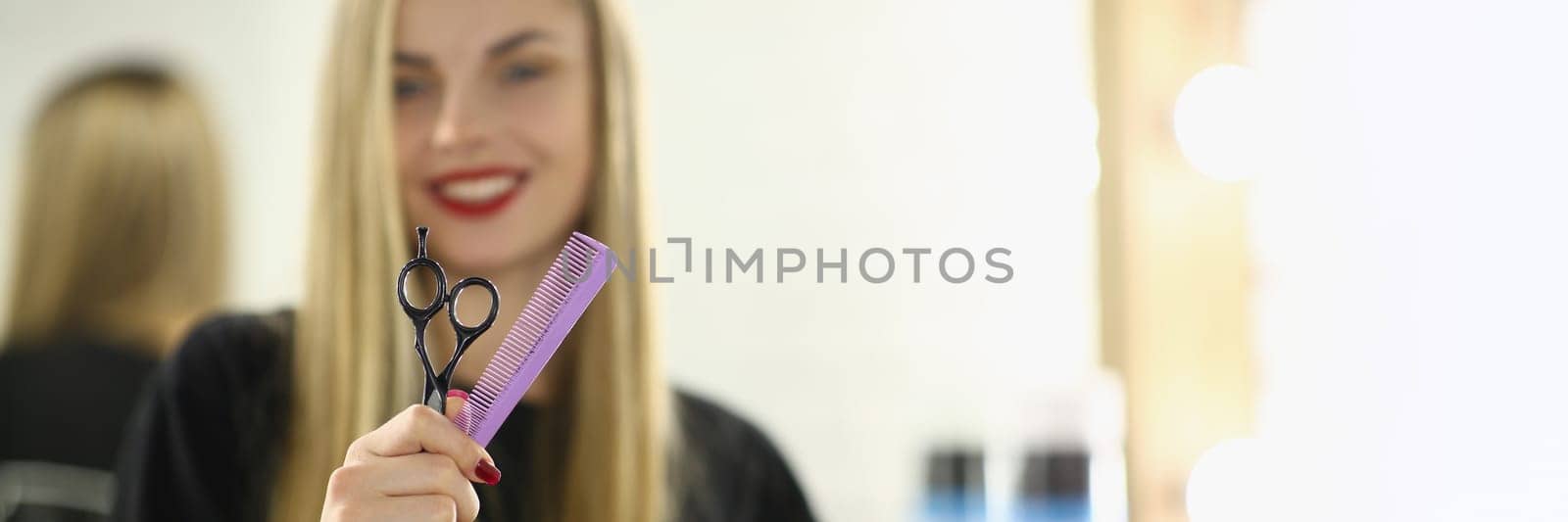 Hairdresser woman holding scissors and comb closeup. Hair styling and care concept