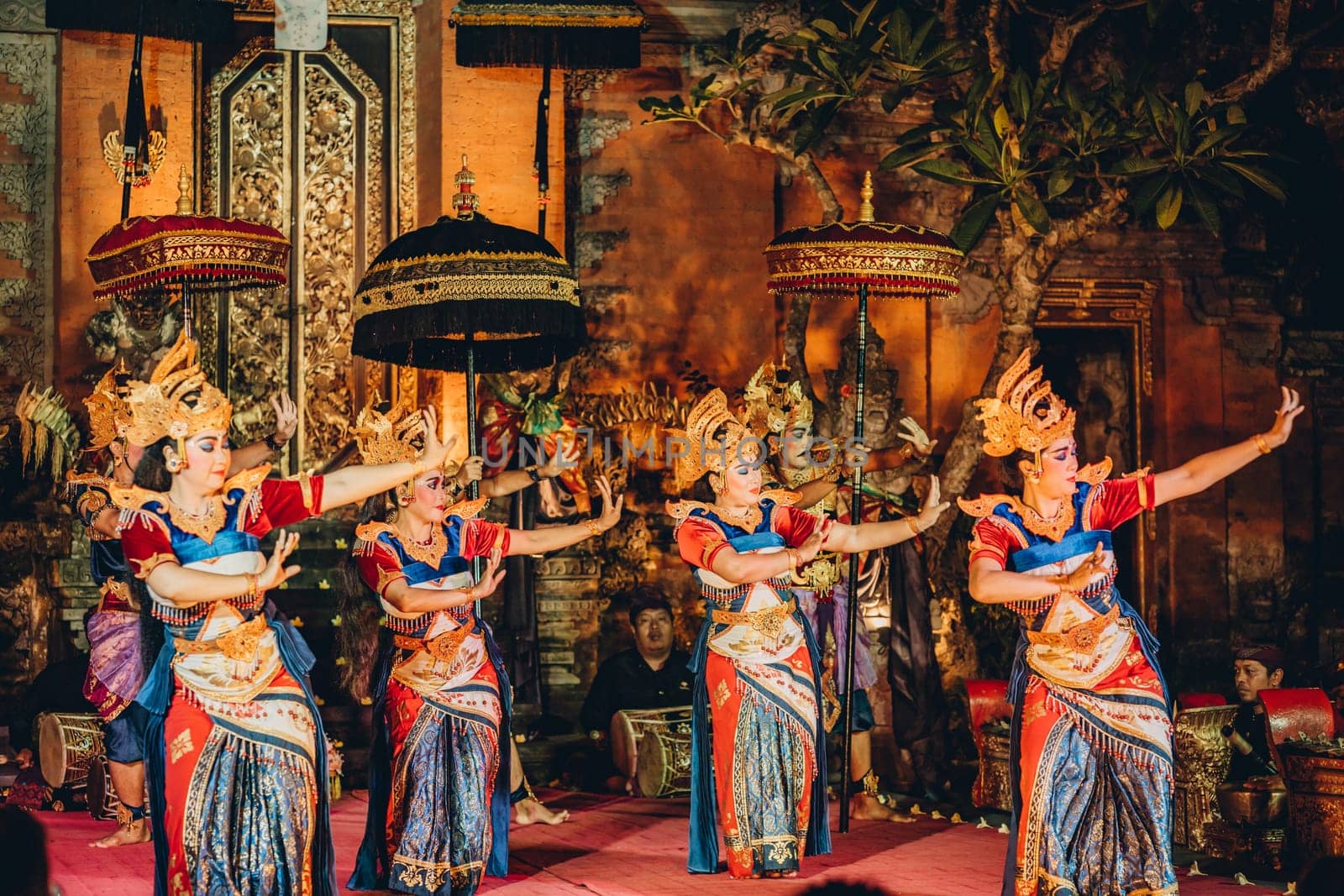 UBUD, BALI, INDONESIA - FEBRUARY 10, 2023: Traditional dance Legong and Barong in Ubud Palace, Balinese dance show with colorful dressed artists. Traditional balinese religious ritual performance