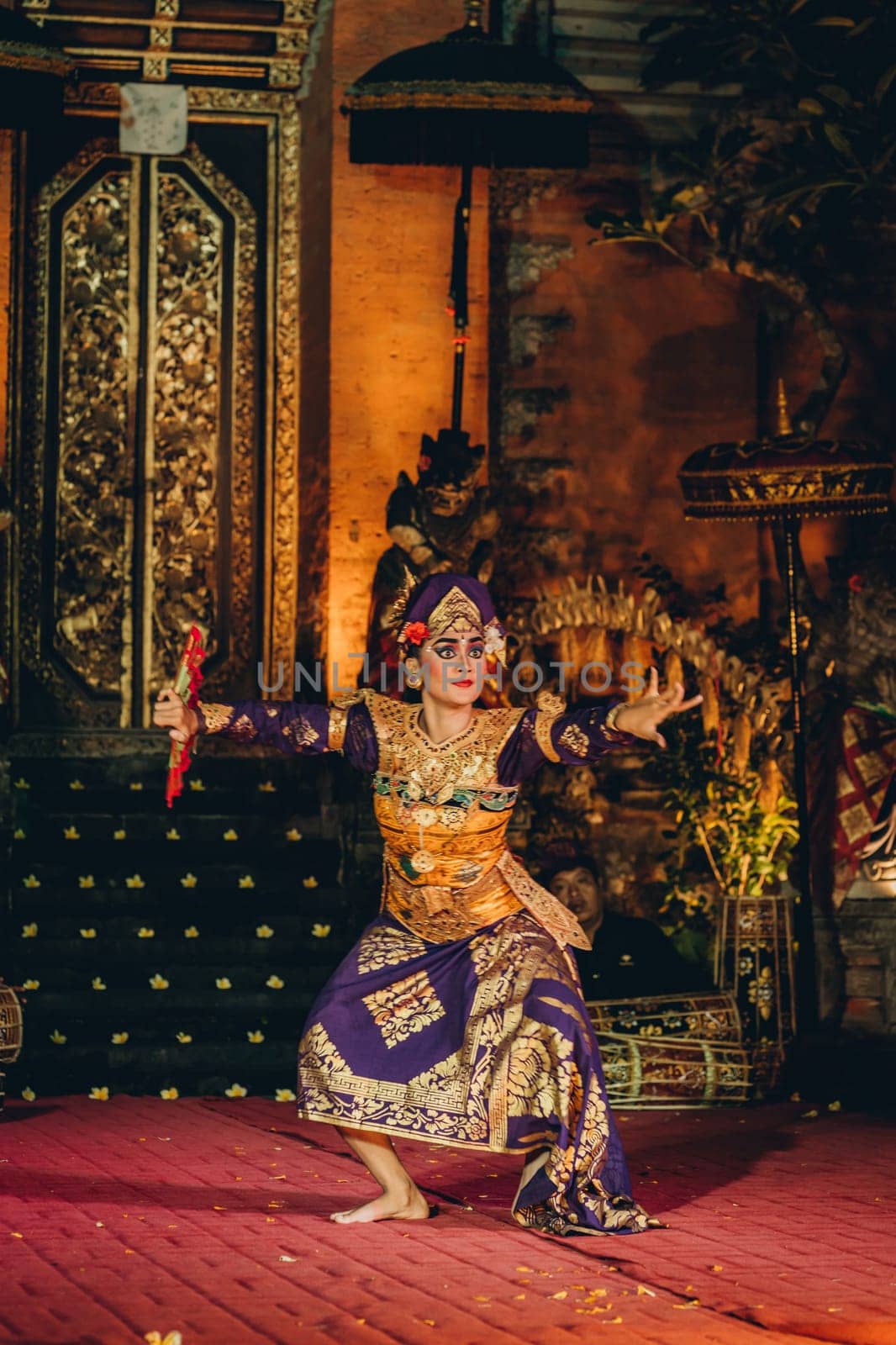 UBUD, BALI, INDONESIA - FEBRUARY 10, 2023: Traditional dance Legong and Barong in Ubud Palace is performed by local professional actors with colorful clothes, expressive gestures, facial expressions