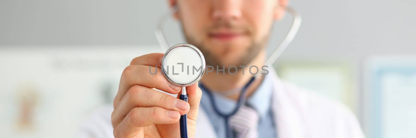 Doctor holds stethoscope in hands and provides medical services. Medical insurance and treatment of cardiac diseases