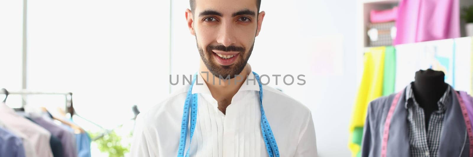 Portrait of male fashion designer stylist in atelier by kuprevich