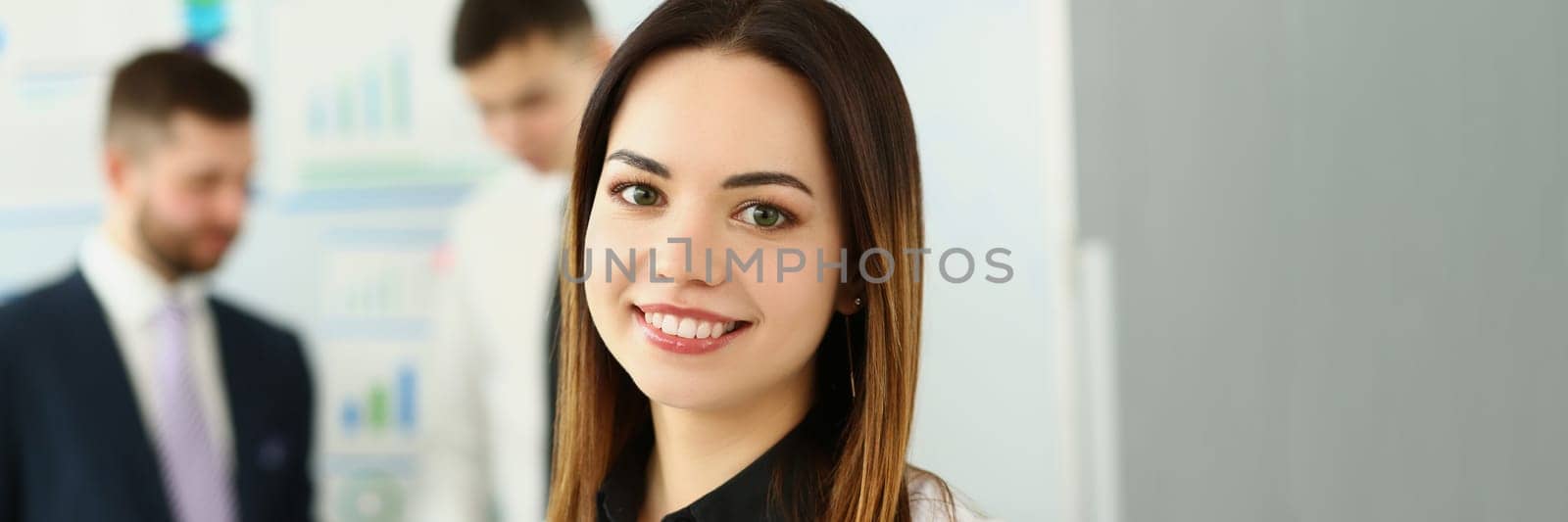 Portrait of smiling businesswoman in the background business partners. Successful career and internship in modern office