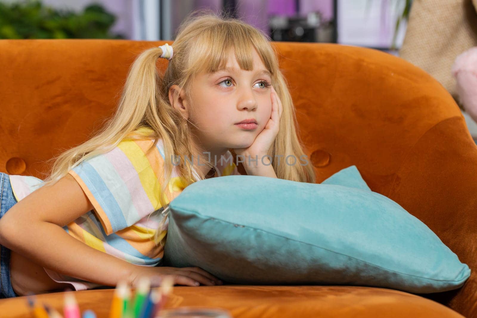 Sad lonely toddler girl at home looks pensive thinks over life concerns or study test exam fail, suffers from unfair situation. Teen child, kid problem, break up, depressed feeling bad annoyed burnout