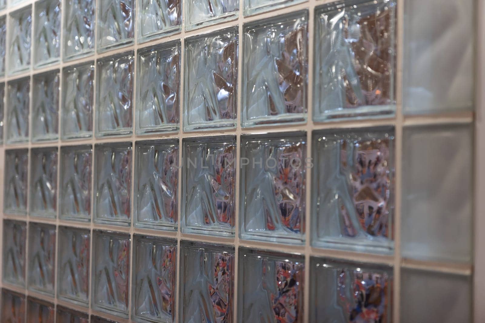 Thick glass block wall background at the expo. Mid shot