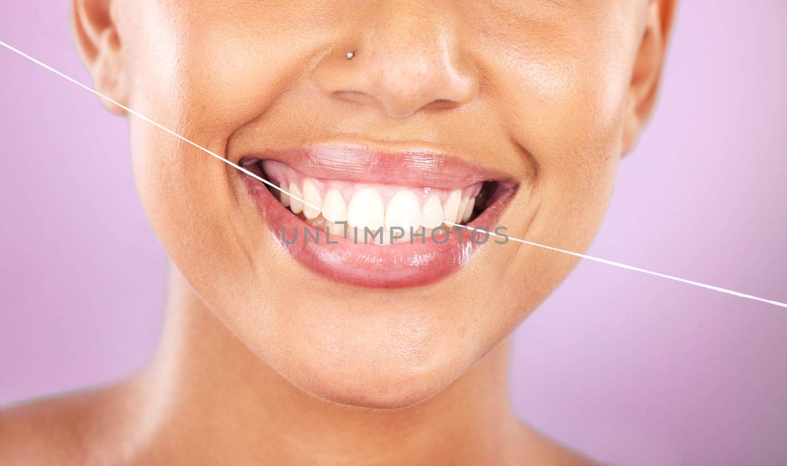 Teeth, dental floss and beauty with woman, face zoom and smile, cosmetic and oral healthcare against purple background. Flossing, fresh breath and health for mouth, teeth whitening with Invisalign