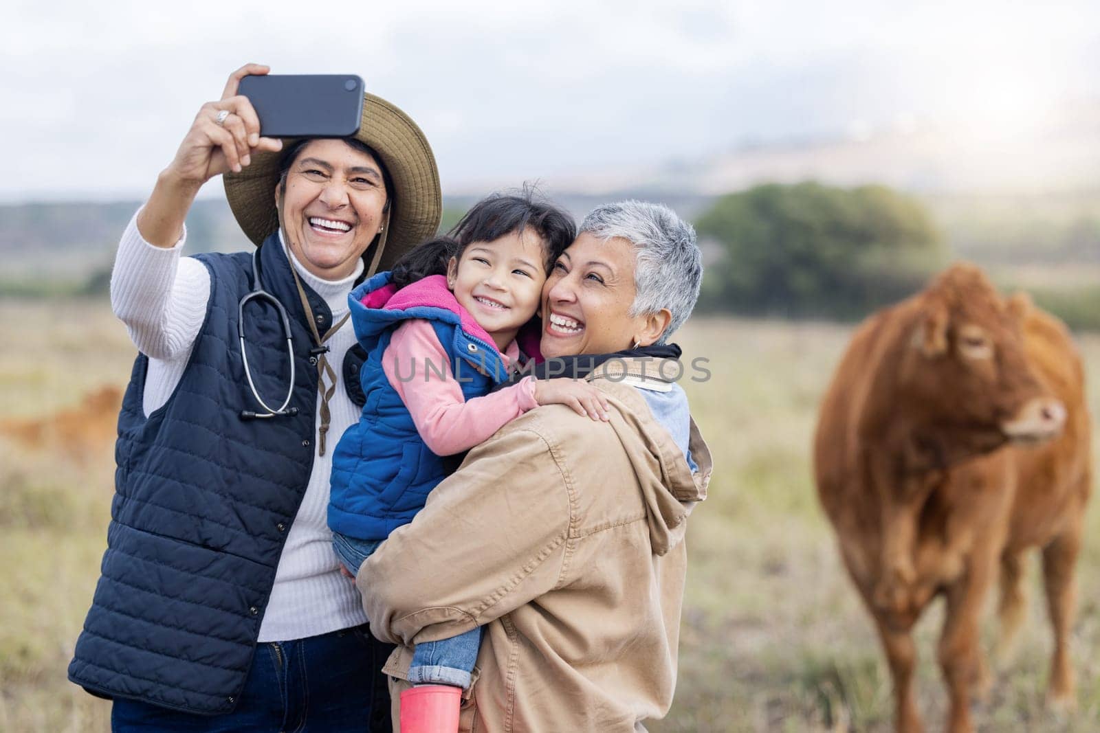 Farm, agriculture and selfie of parents and girl in countryside for holiday, vacation and adventure on field. Lesbian couple, family adoption and photo of child with mom for quality time on cow ranch.