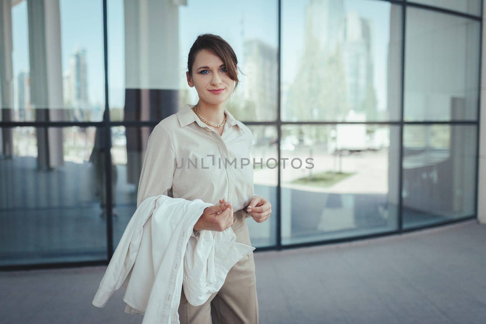 Beautiful caucasian blond woman going to work near office building.