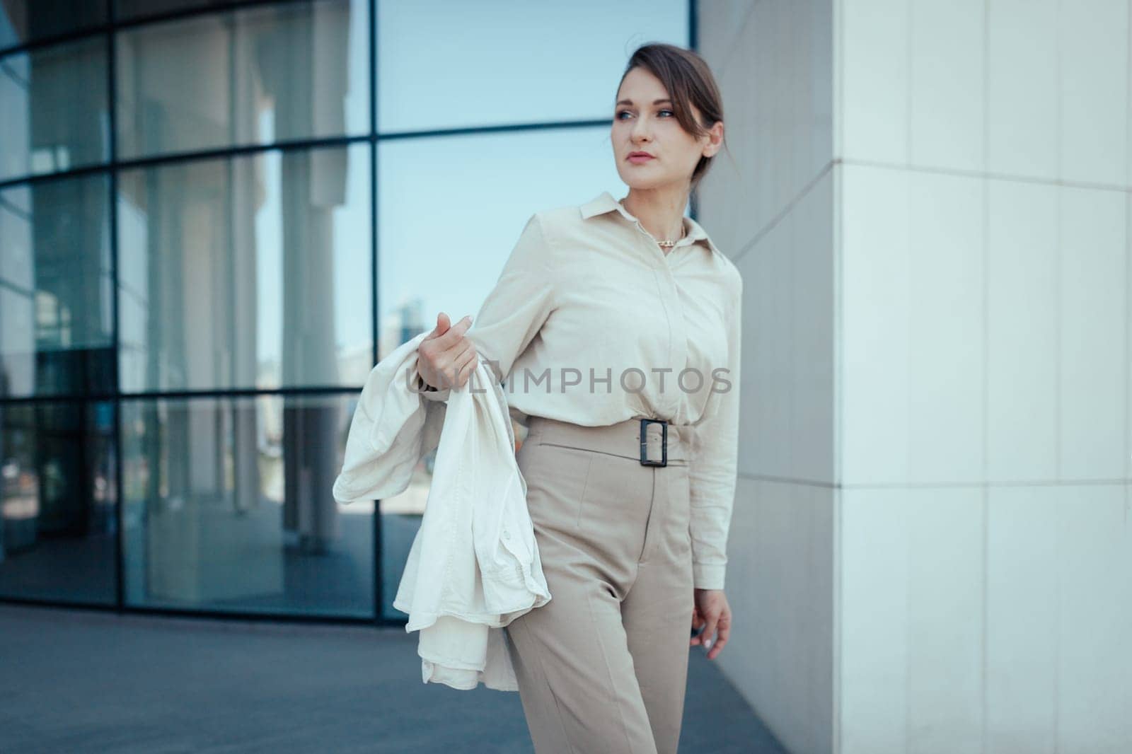Outdoor shot of caucasian business woman, going somewhere in city centre, walking on street, going to work.