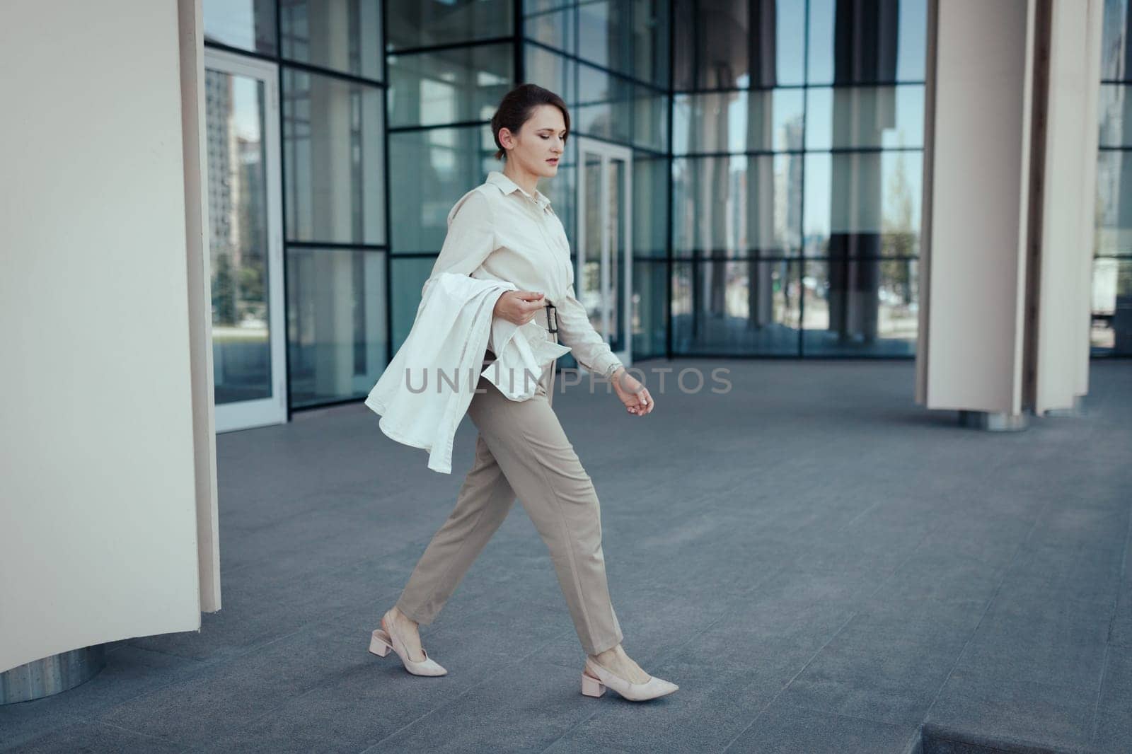 Active lifestyle of caucasian career business woman walking from work place office.