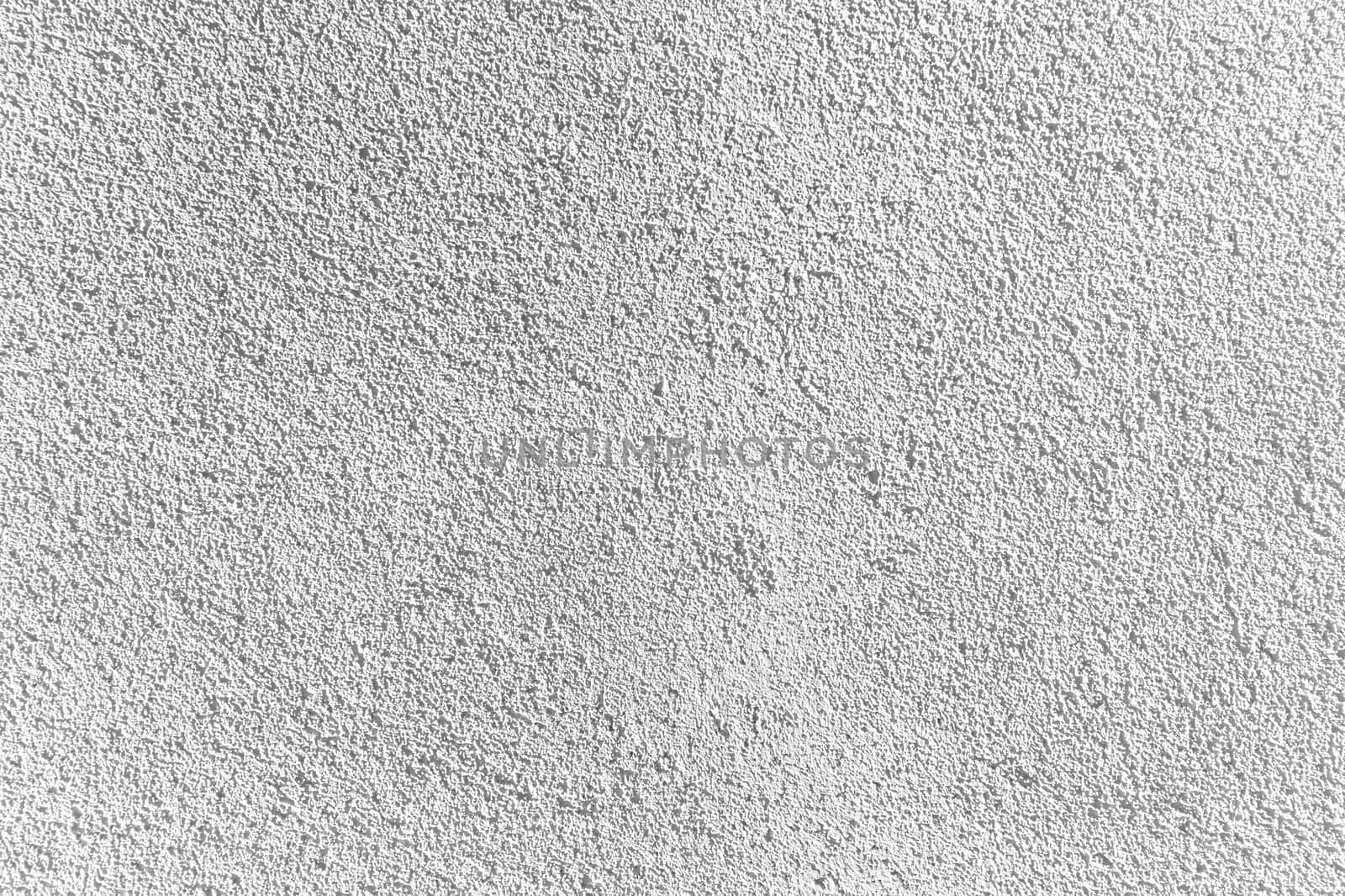 White gray uniform background of decorative textured plaster on the wall, grunge background.