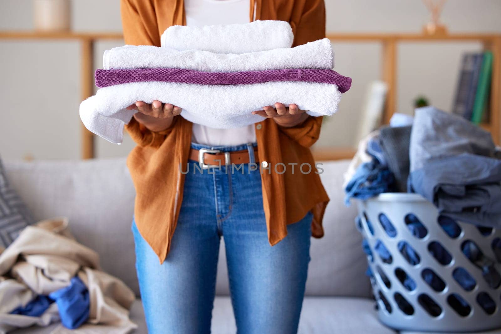 Laundry, towel and texture with cleaning service and woman cleaner, hygiene and disinfection for housekeeping. Spring cleaning, clean fabric and housekeeper with fresh textile, washing and house work by YuriArcurs