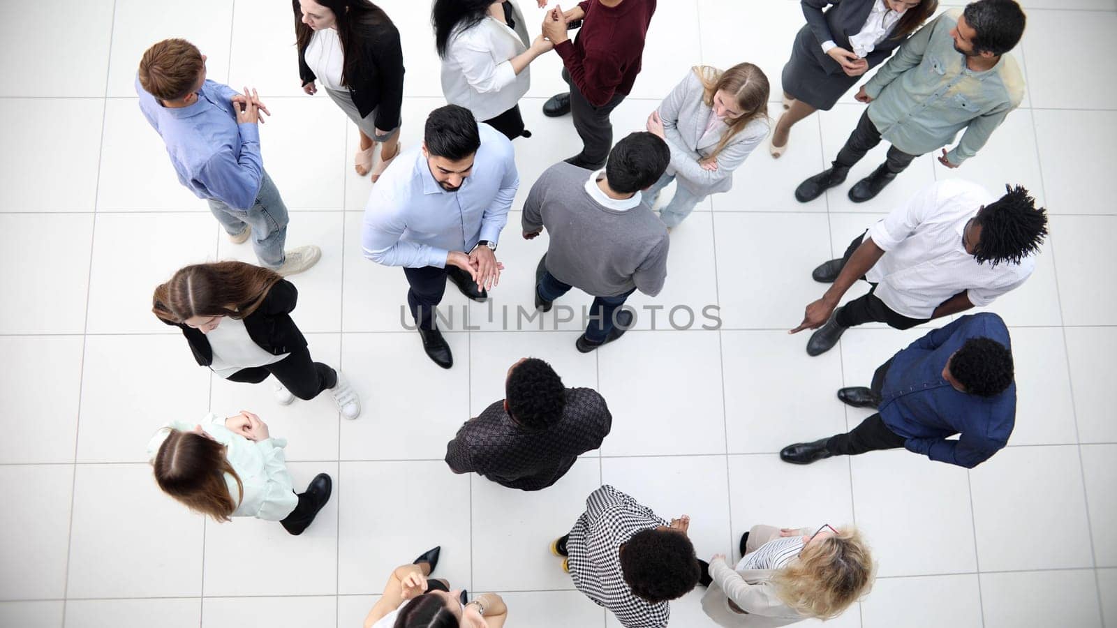 Group of company workers walking in office corridor