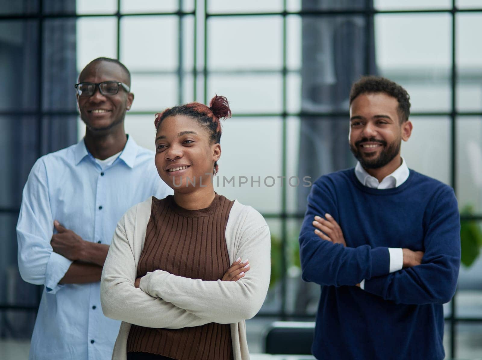 Successful african american business team standing with arms crossed in the office