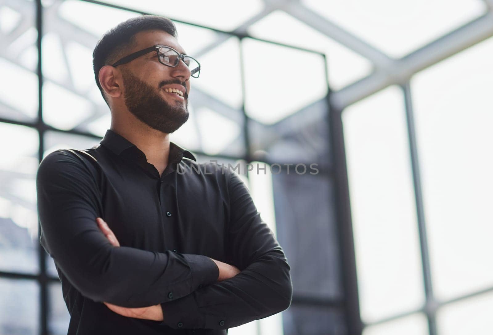 Businessman portrait. Happy confident young businessman standing , smiling, looking at camera.