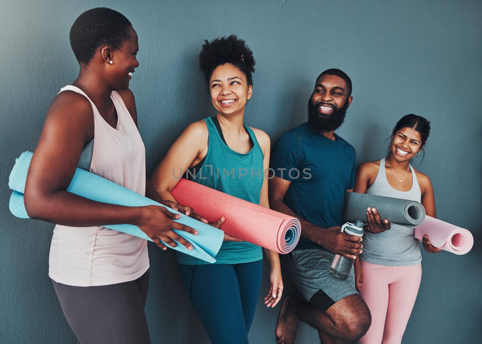 Yoga, talking friends and wall of pilates class in a gym with a exercise and training break. Conversation, wellness and communication of black people together ready for zen, balance and relax by YuriArcurs