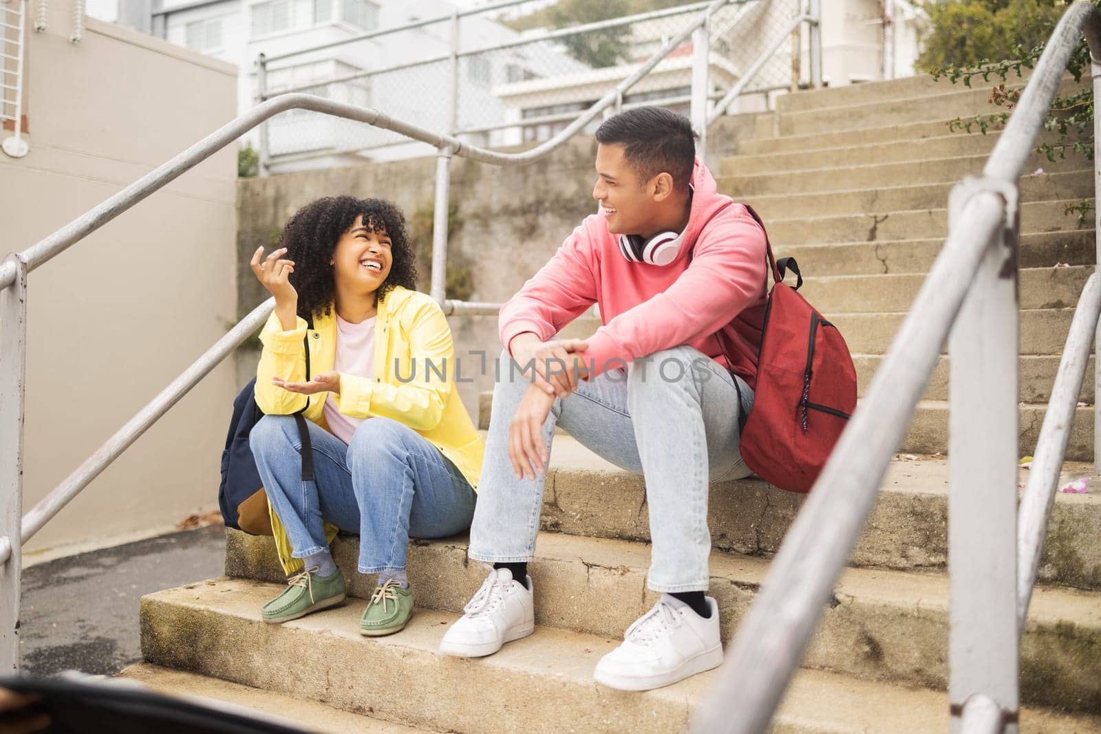 Student, friends and conversation on stairs talking about social life, class or education at the campus. Young academic university or college students chilling on staircase in funny discussion.