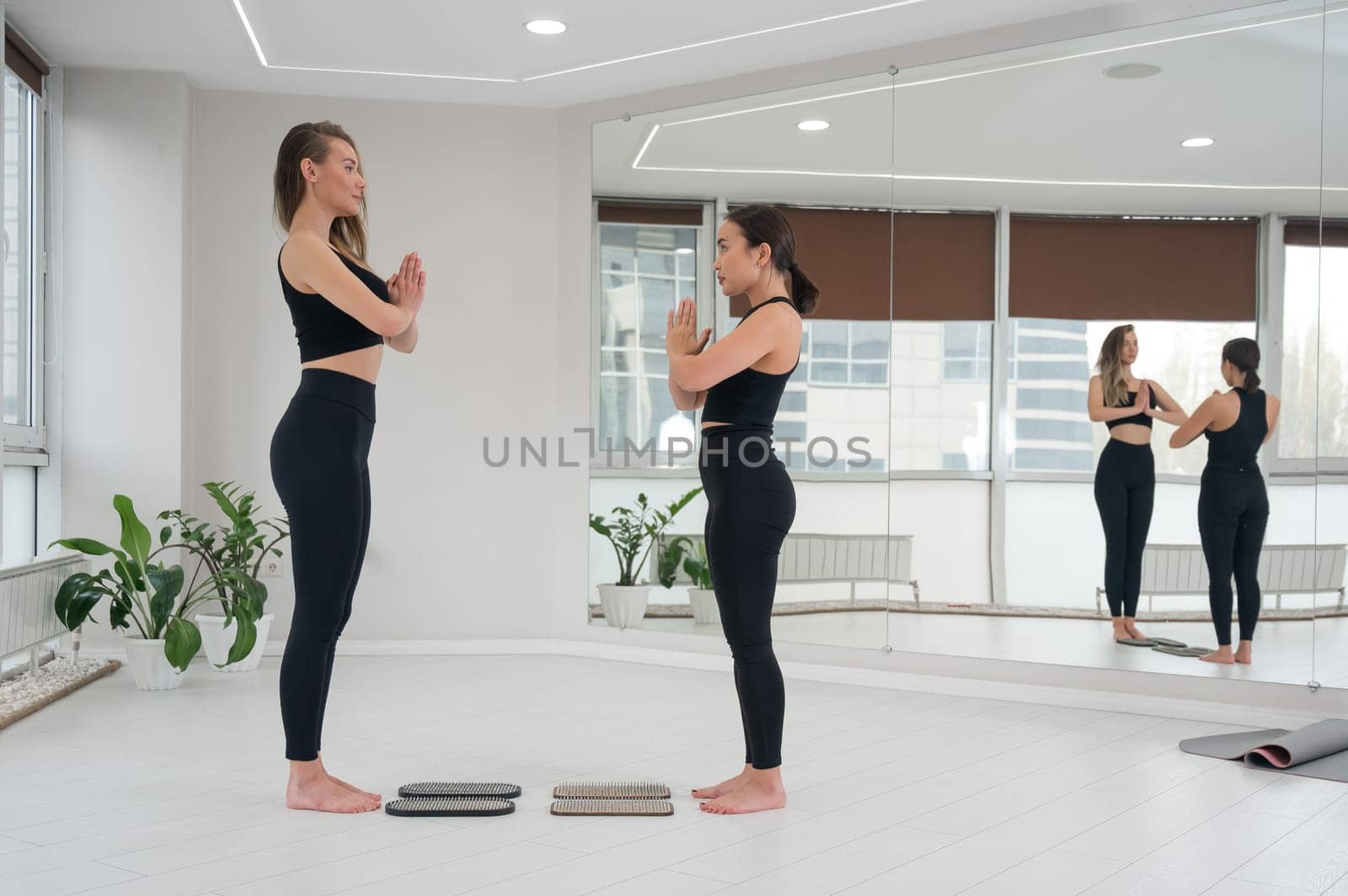 Two women meditate before practicing nailing on sadhu boards