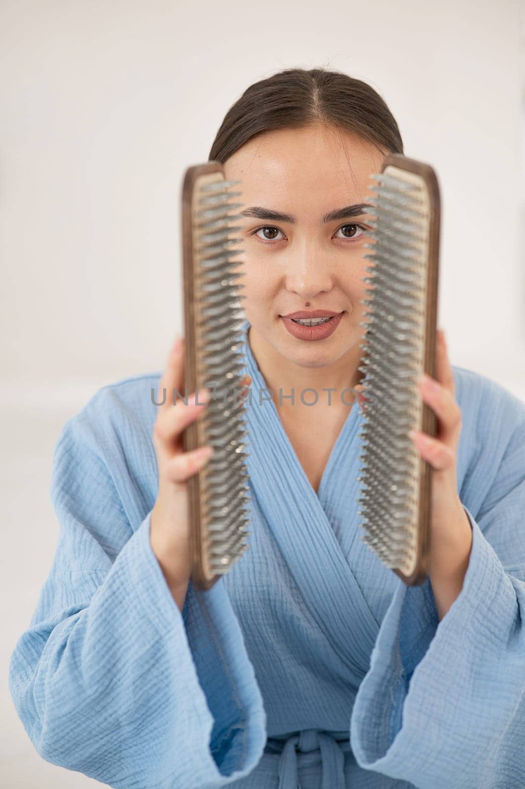 Asian woman holding sadhu boards on face background