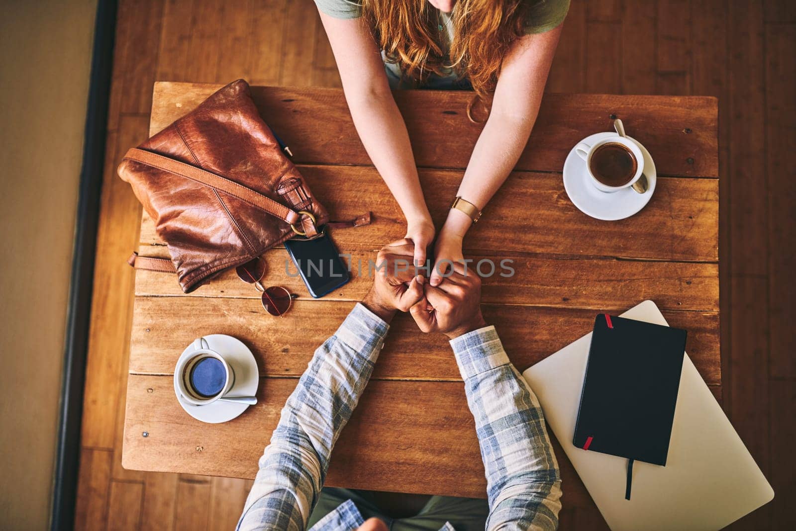 Above, couple and cafe at table with holding hands, love or conversation for romance together. Man, woman and valentines date in coffee shop for support, bonding or talk for happiness, care and trust.