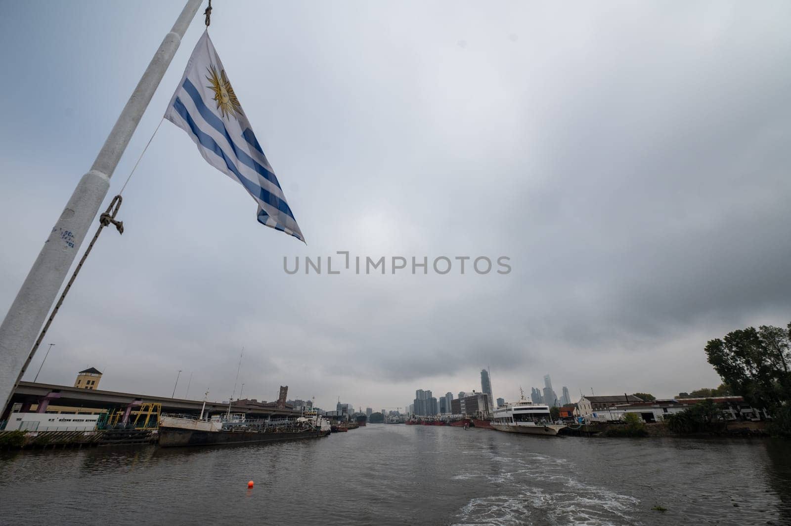 Buenos Aires, Argentina : April 21, 2023 : Uruguayan flag on the Colonia Express ship leaving the port of Buenos Aires in April 2023.