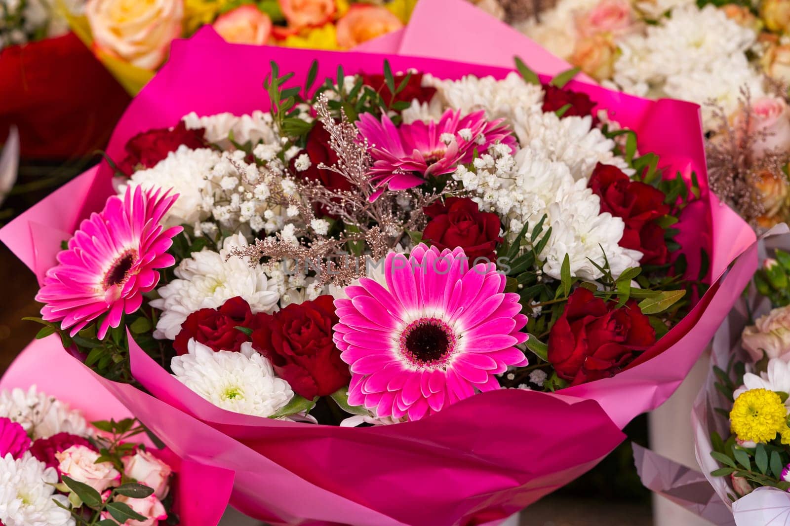 Mixed colorful flowers background. Vibrant colors of gerbera, tulips mix of summer flowers bouquet by PhotoTime
