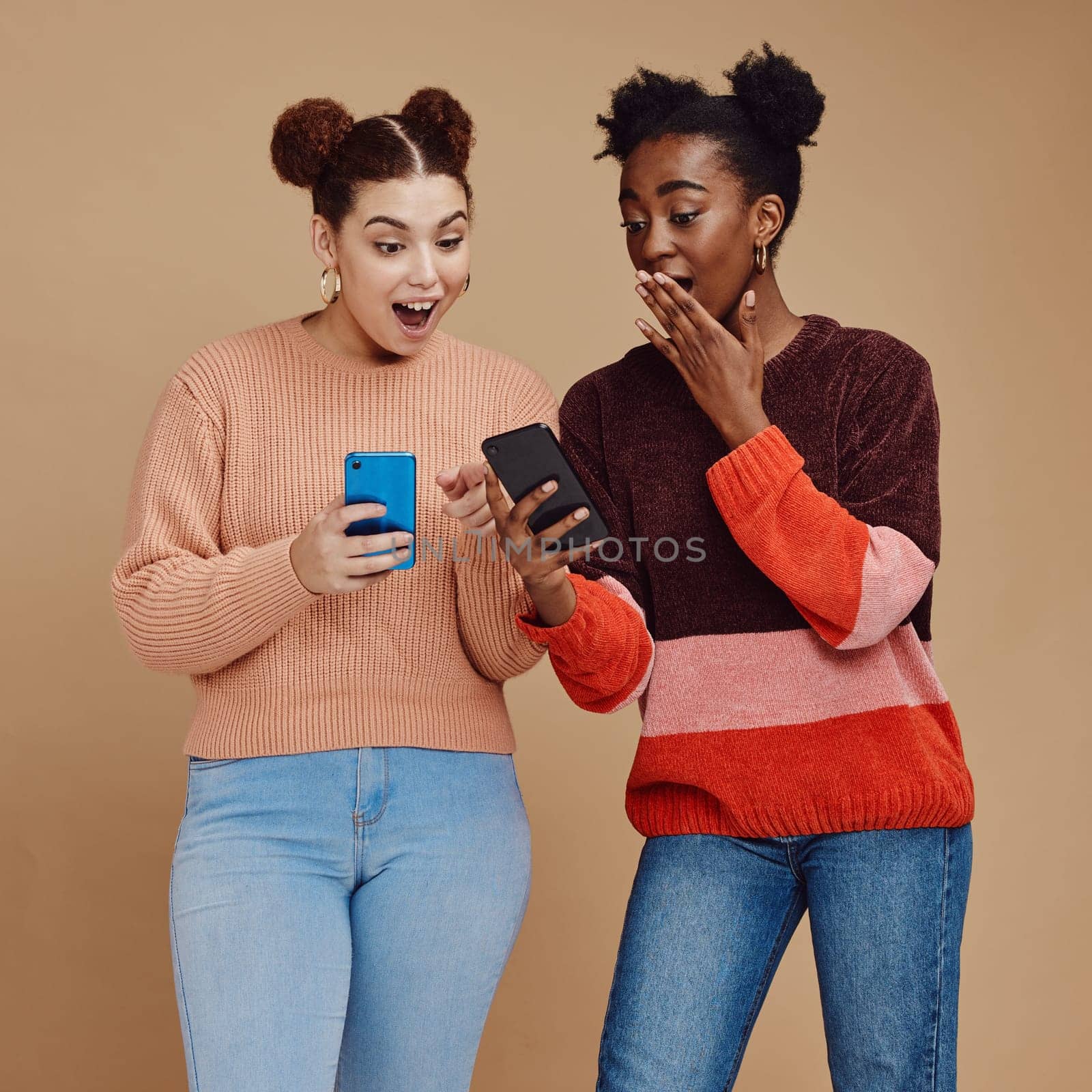 News, wow and shocked people isolated on studio background for social media, gossip or trendy online sale. Smartphone, surprise notification and gen z friends, black woman reading announcement mockup by YuriArcurs
