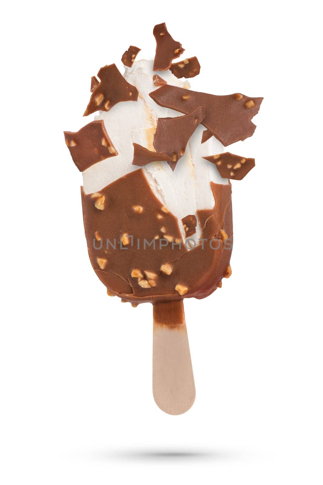 Chocolate ice cream isolate on a stick flying pieces of chocolate icing. Chocolate ice cream on a white isolated background with scattered pieces of chocolate and vanilla inside