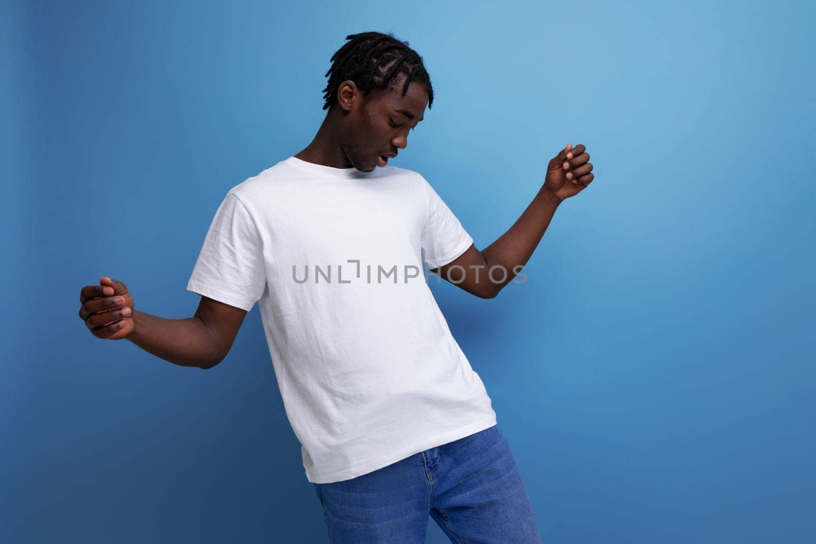 charming african young adult with dreadlocks in white t-shirt with blank space for logo by TRMK