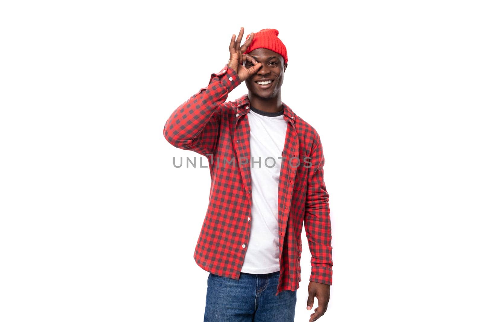 young ethnic african man in stylish look smiling on white studio background with copy space by TRMK