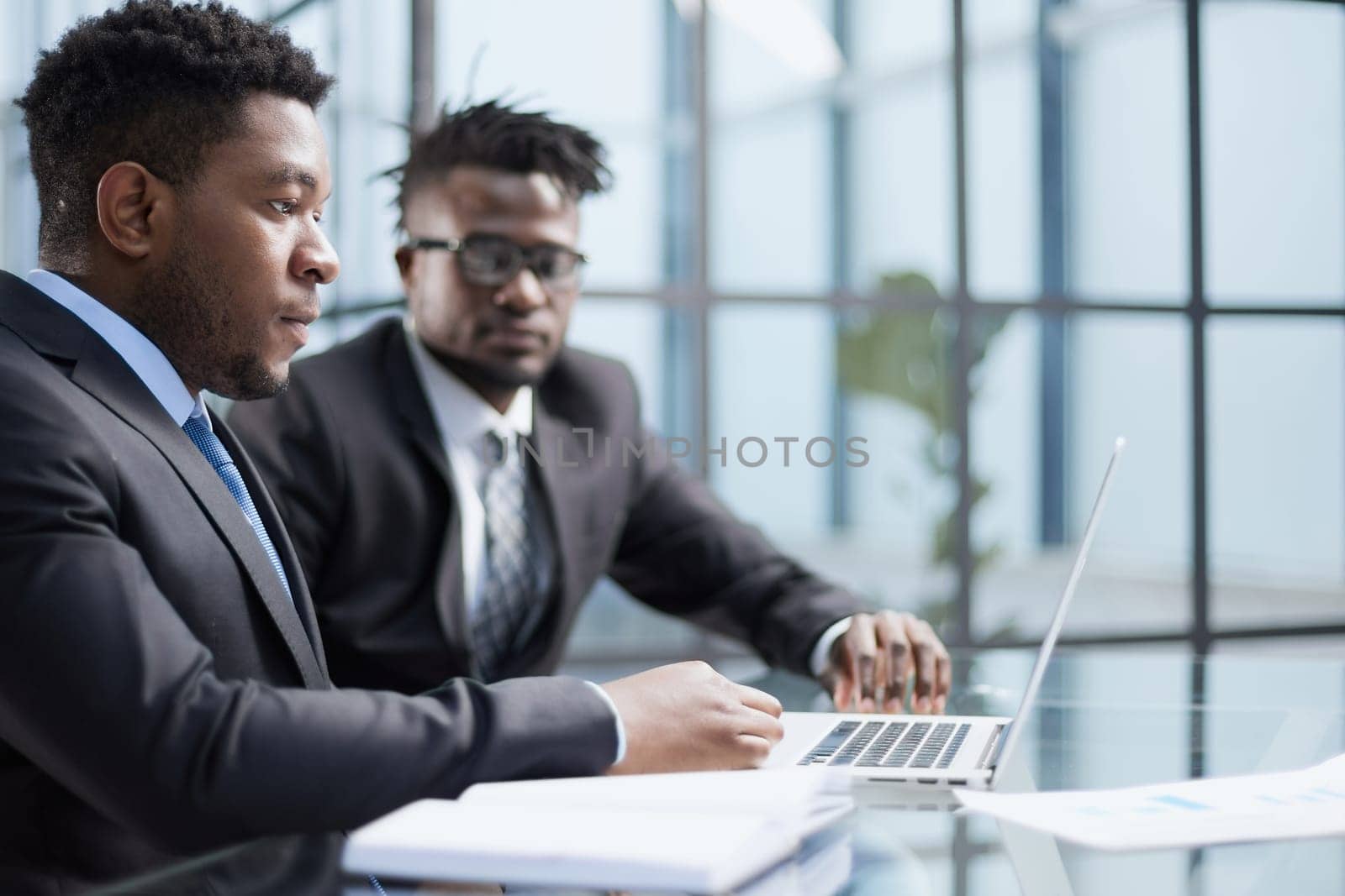 African american boss negotiating discussing contract details with company corporate client.