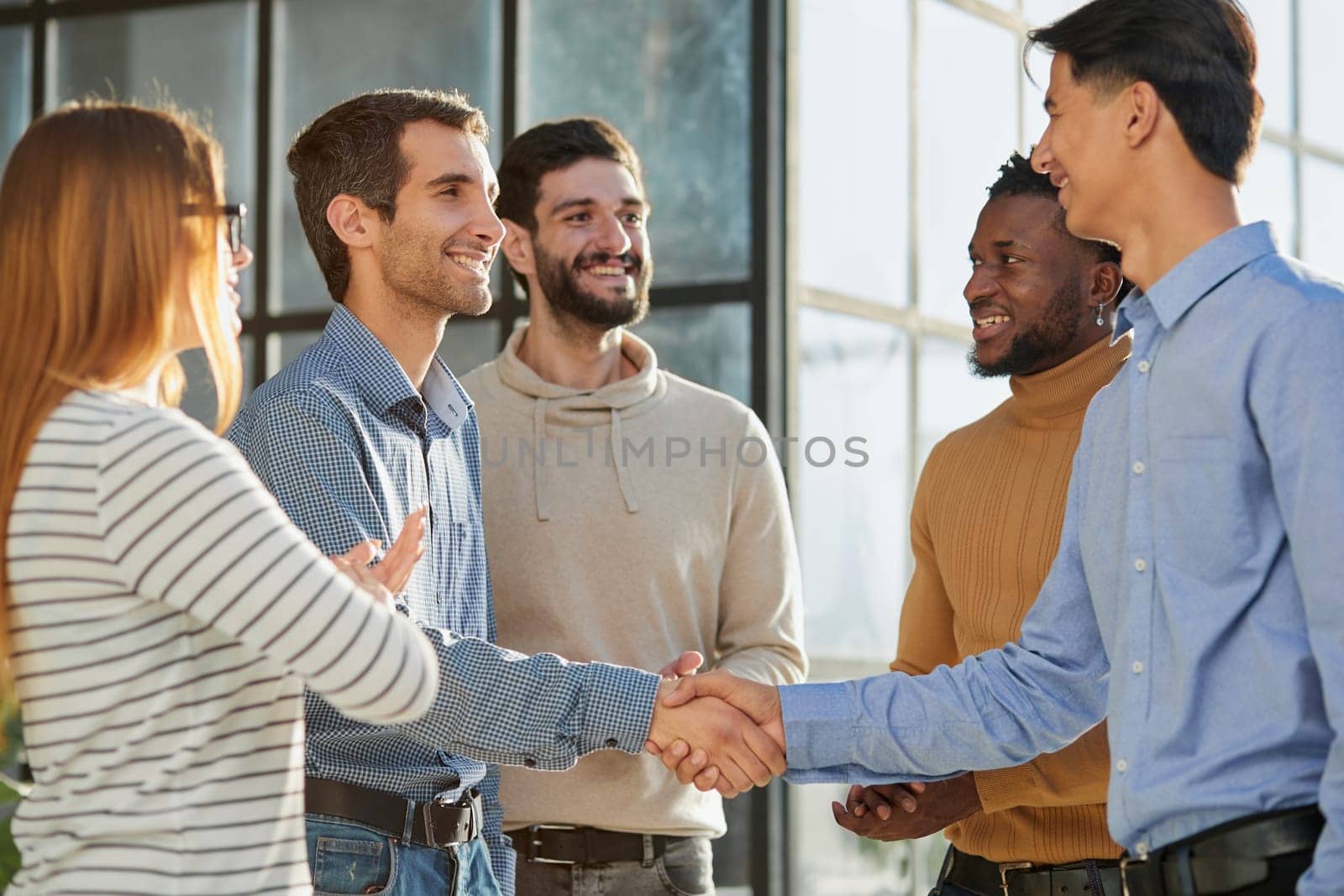 friendly hr manager or team leader greeting or welcoming new worker