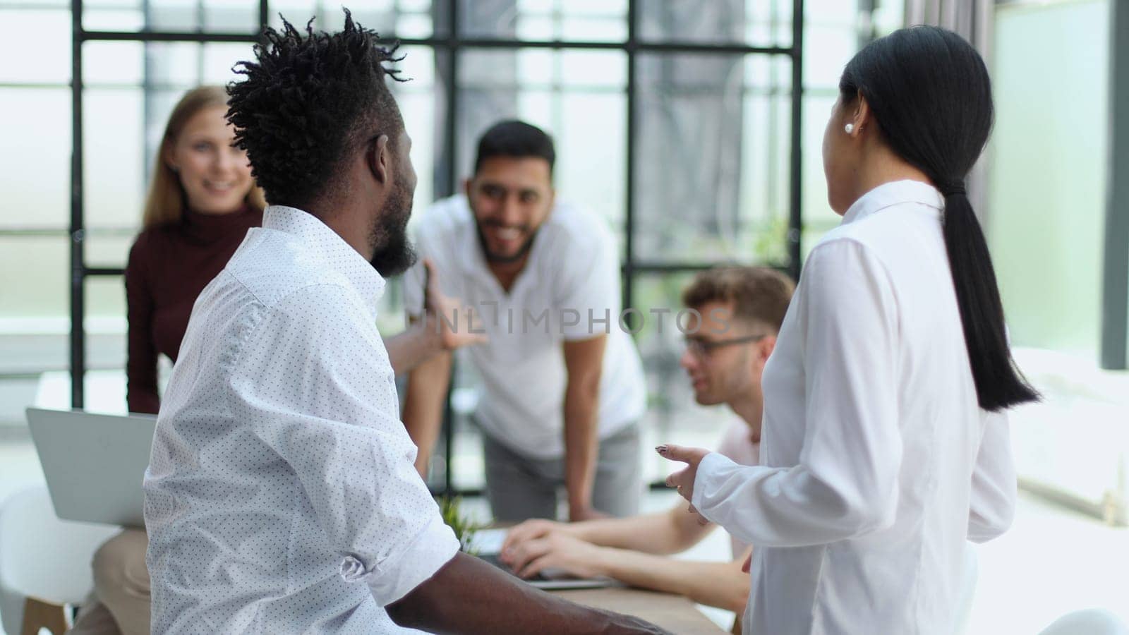 Welcome to our team Handshake while working in a creative office. Success concept