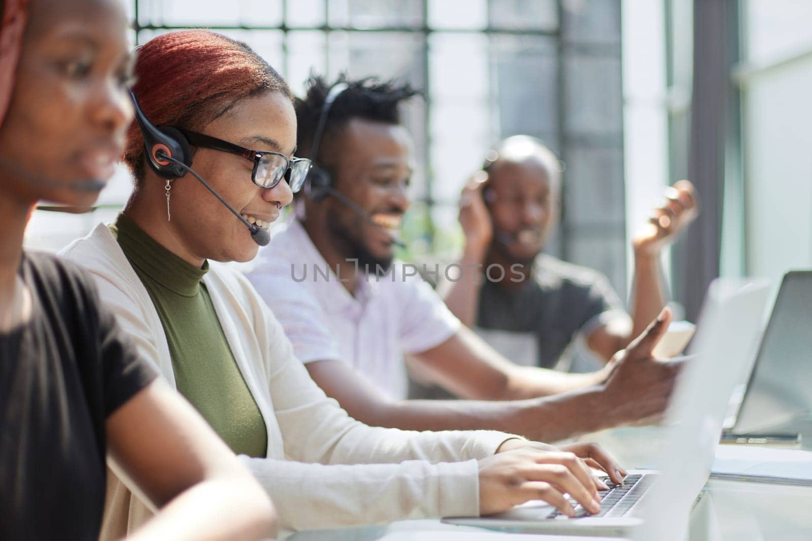 Call Center Operator With Colleagues At Workplace
