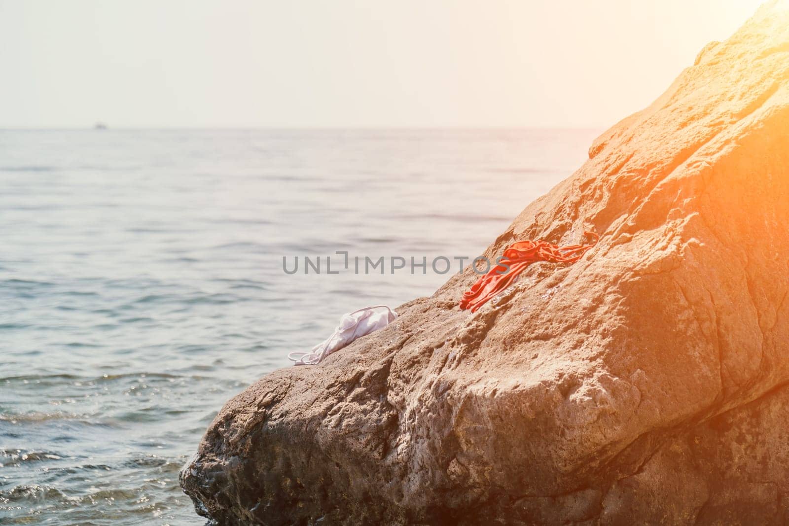 Woman summer sea. Happy woman swimming with inflatable donut on the beach in summer sunny day, surrounded by volcanic mountains. Summer vacation concept