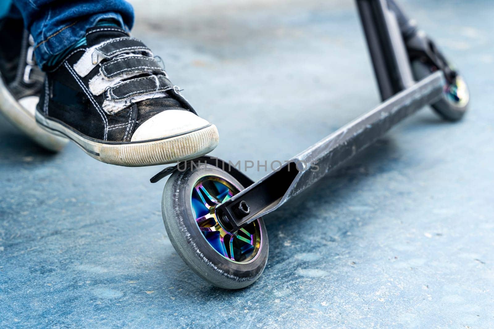 Rider boy legs close up in sneakers on stunt scooter by audiznam2609