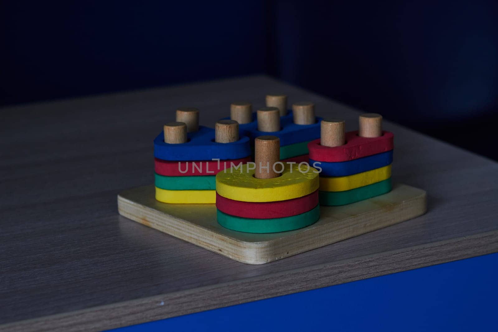 Photo of children's sorter wooden base with plastic figures. Educational and educational toys. Childhood. Training.